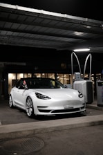 white mercedes benz coupe parked on parking lot during night time