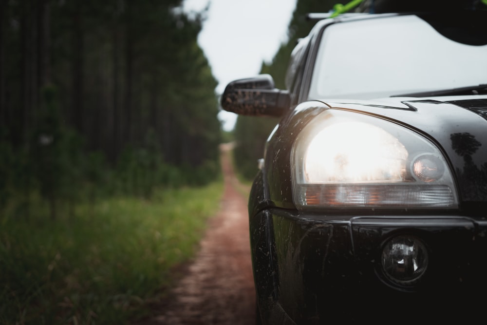 black car on dirt road during daytime