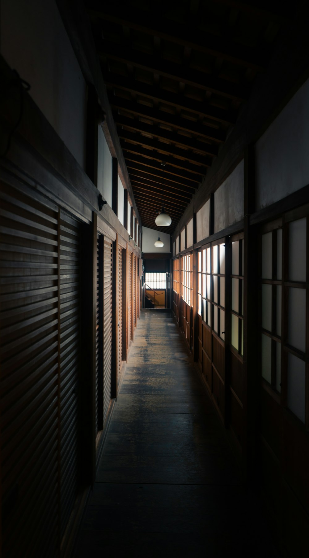 brown wooden hallway with white ceiling light