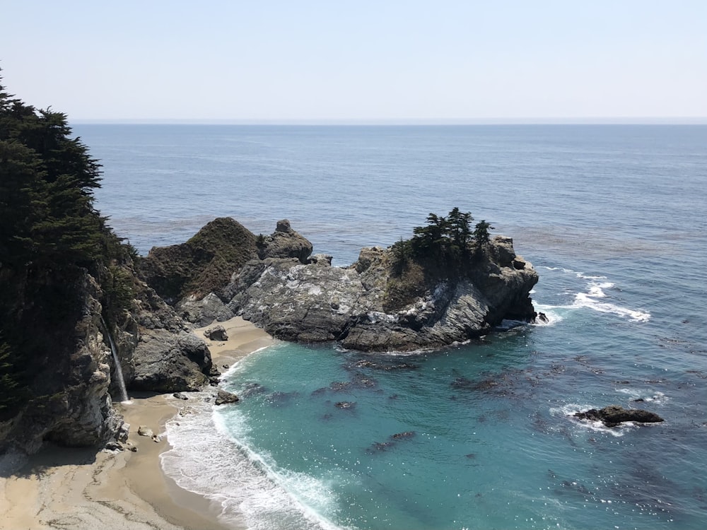 brown rock formation on sea shore during daytime