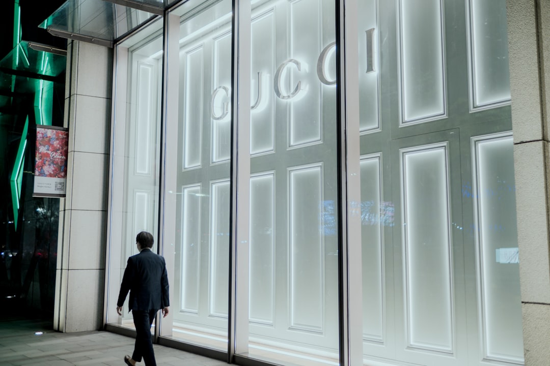 man in black coat walking on hallway