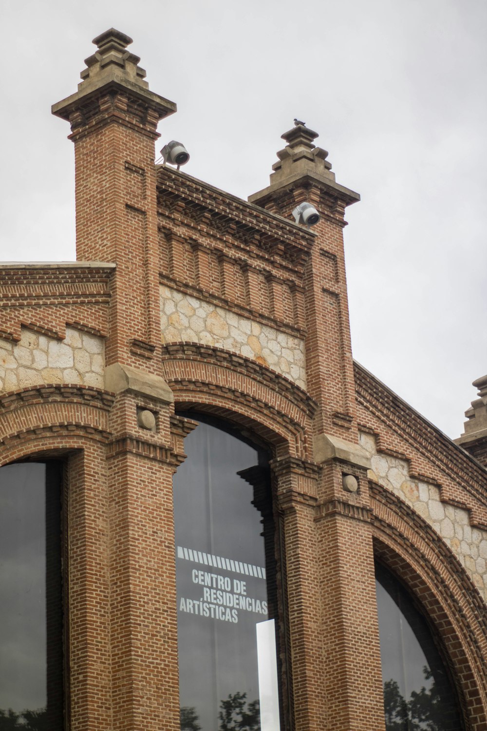 brown brick building under white sky during daytime