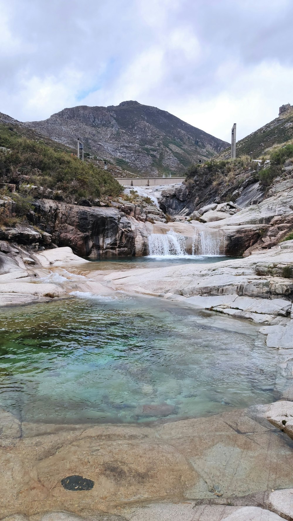 green and gray mountain beside river