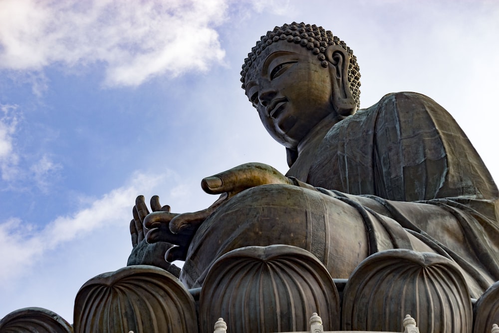 brown concrete statue under blue sky during daytime