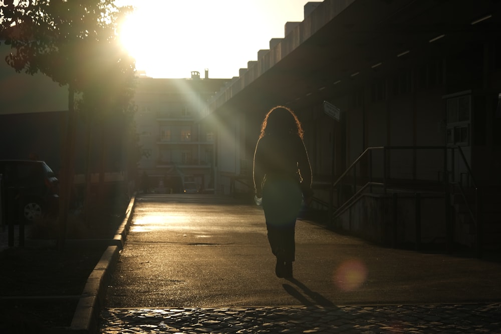 man in black jacket walking on street during daytime