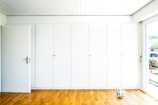 white and red toy car on brown wooden parquet floor