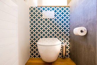 Close-up of a decorative toilet seat with a sleek, modern design in a stylish bathroom.
