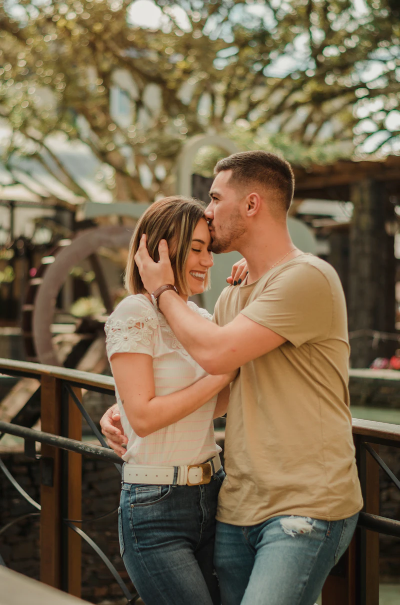 A couple kissing outdoors in summer