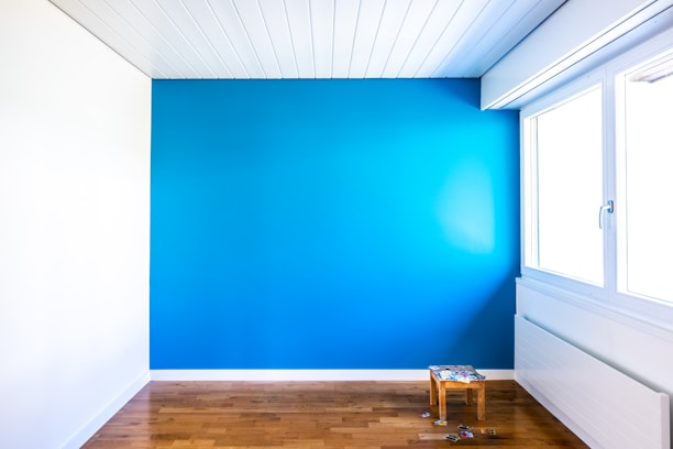 Bright bedroom with minimalist decor and soft blue accents.