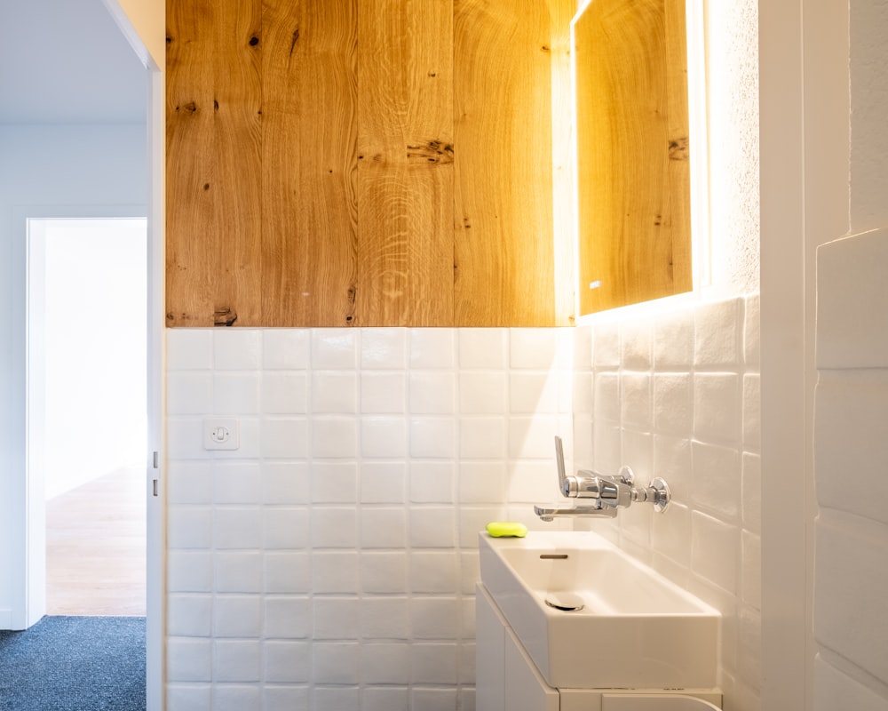 white ceramic sink beside brown wooden cabinet