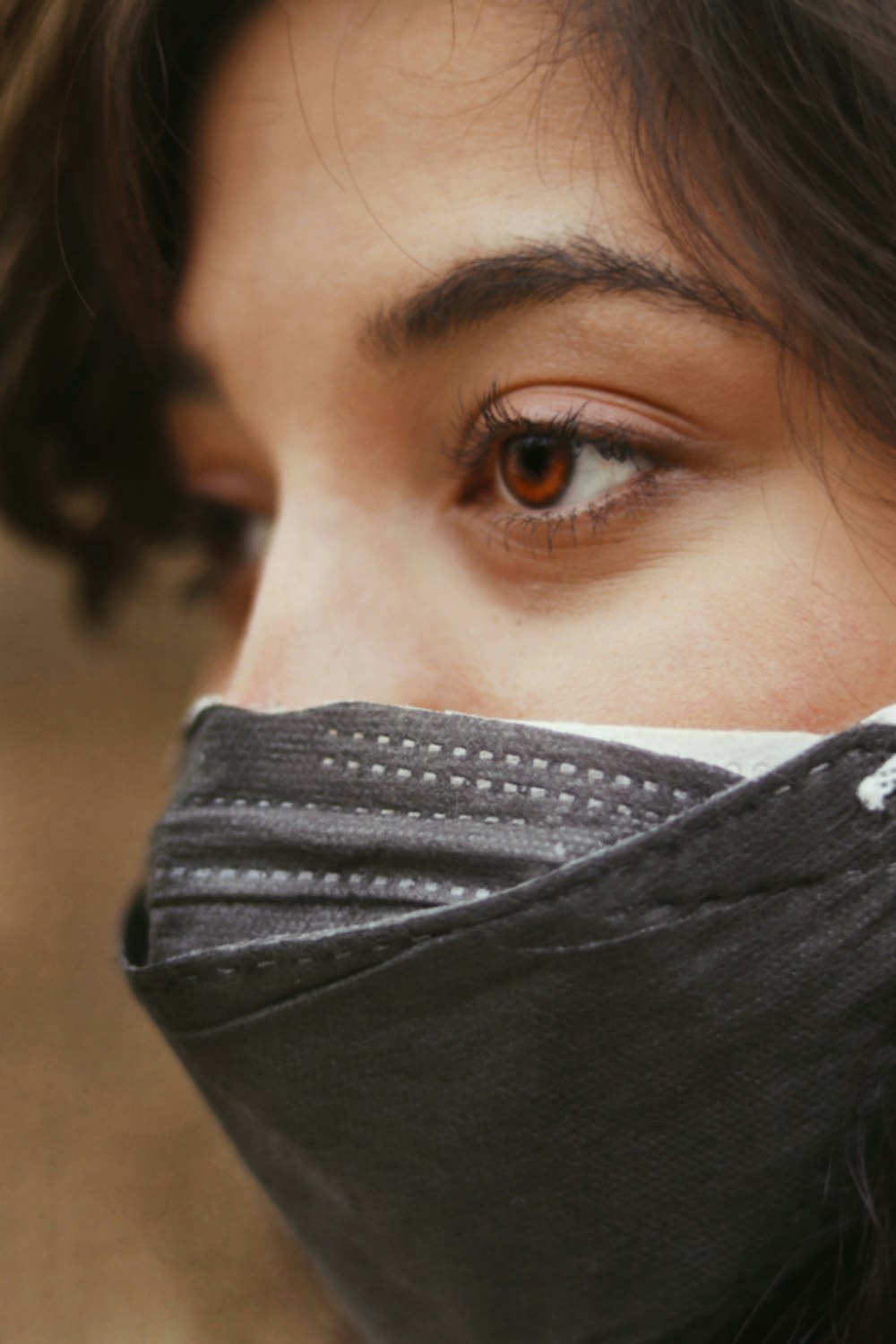 woman covering her face with black textile