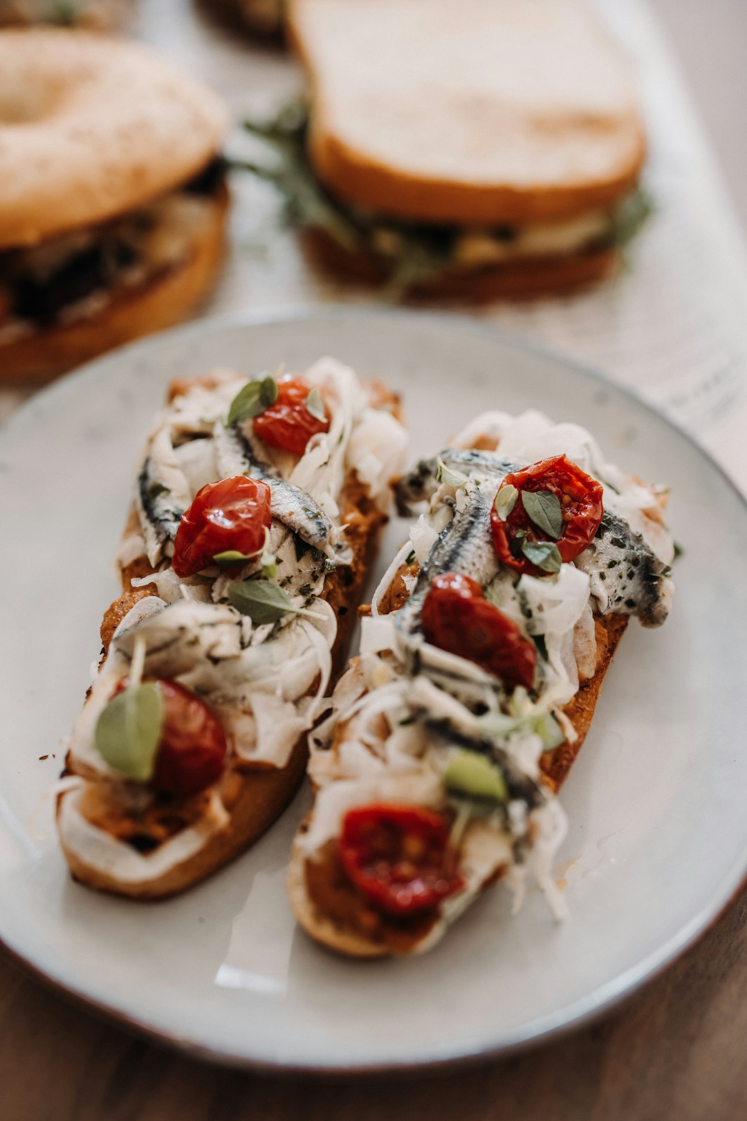 brown bread with white cream and red sauce on white ceramic plate