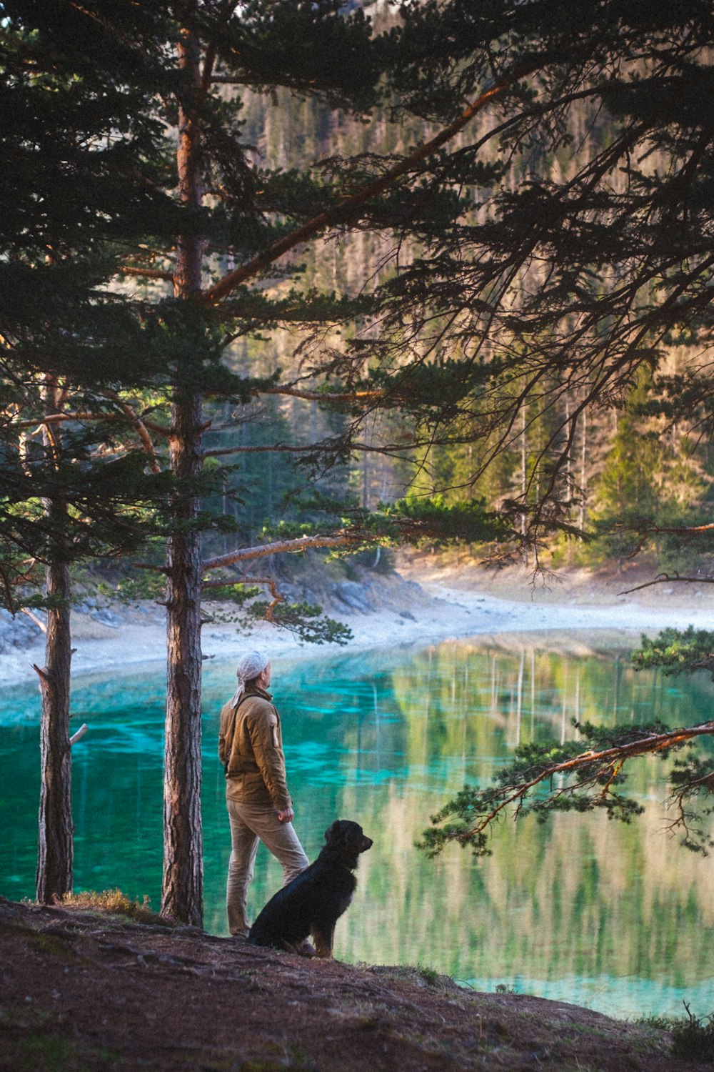 man in black jacket standing beside river during daytime