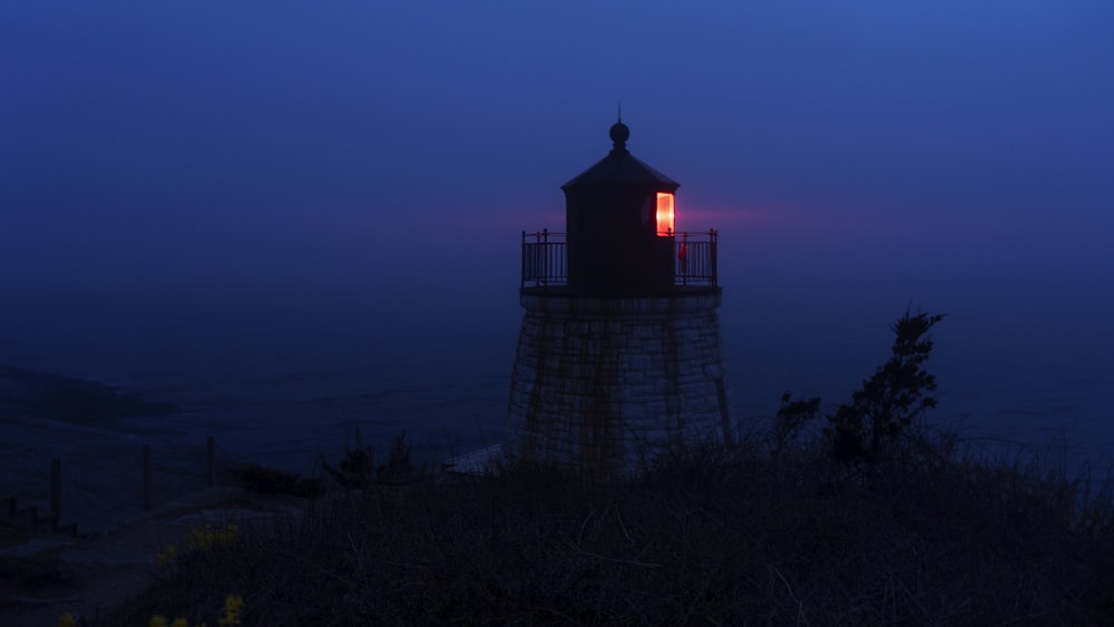 silhouette of lighthouse during night time