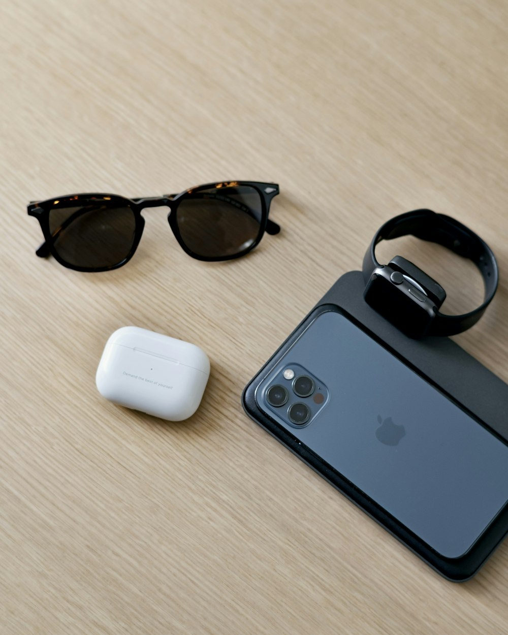 black framed sunglasses beside white apple airpods