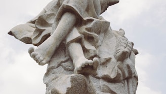A detailed stone sculpture of a human figure.