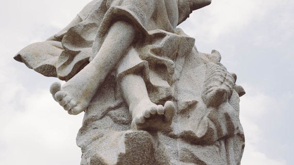 A detailed stone sculpture of a human figure.
