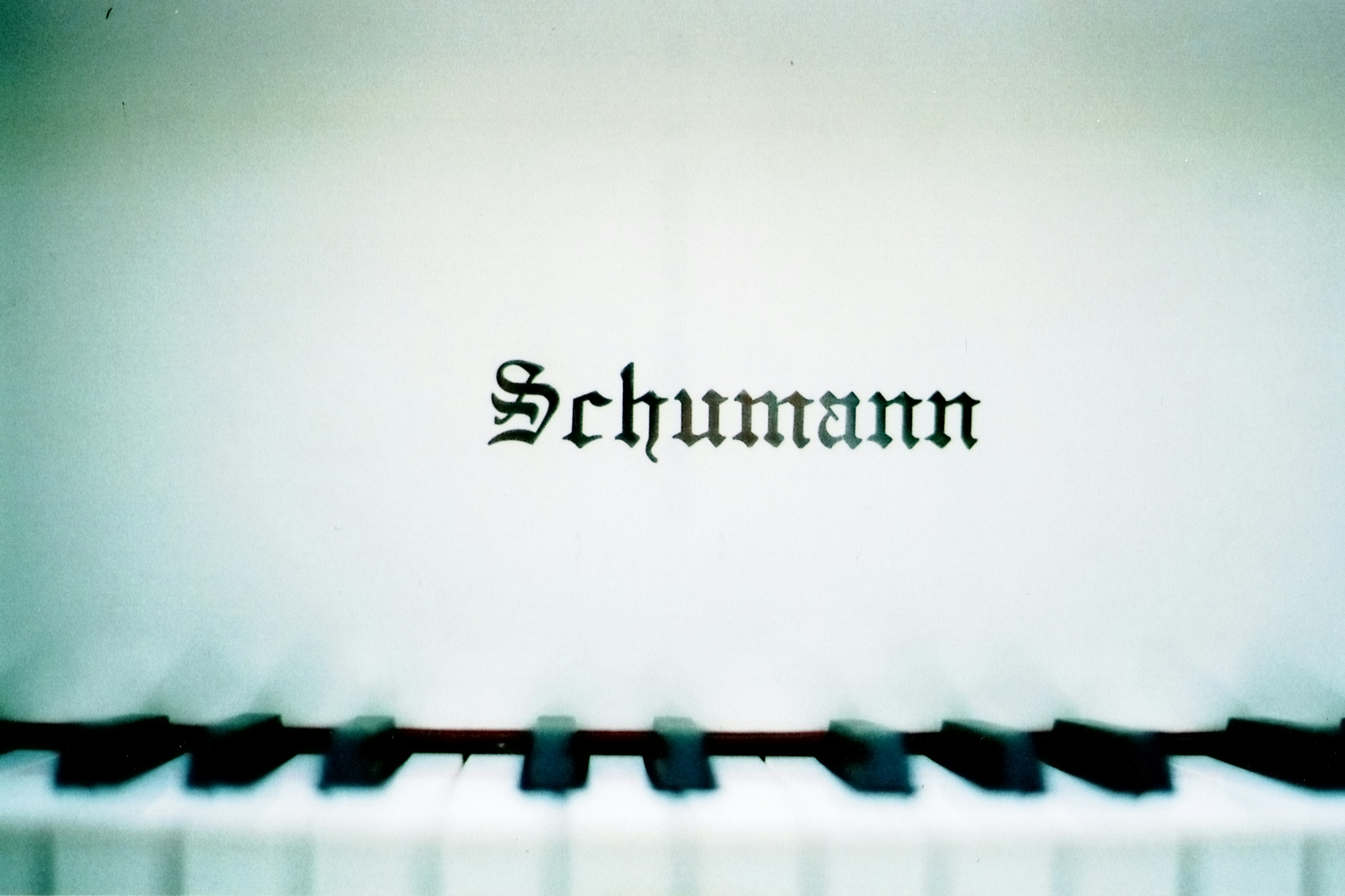 a close up of a piano keyboard with the word schmam on it