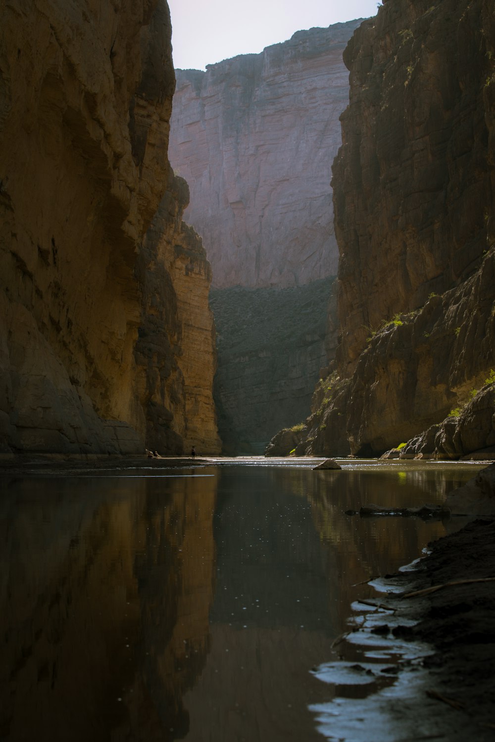 river between brown rock formation during daytime