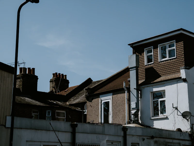 A white and brown house under a blue sky