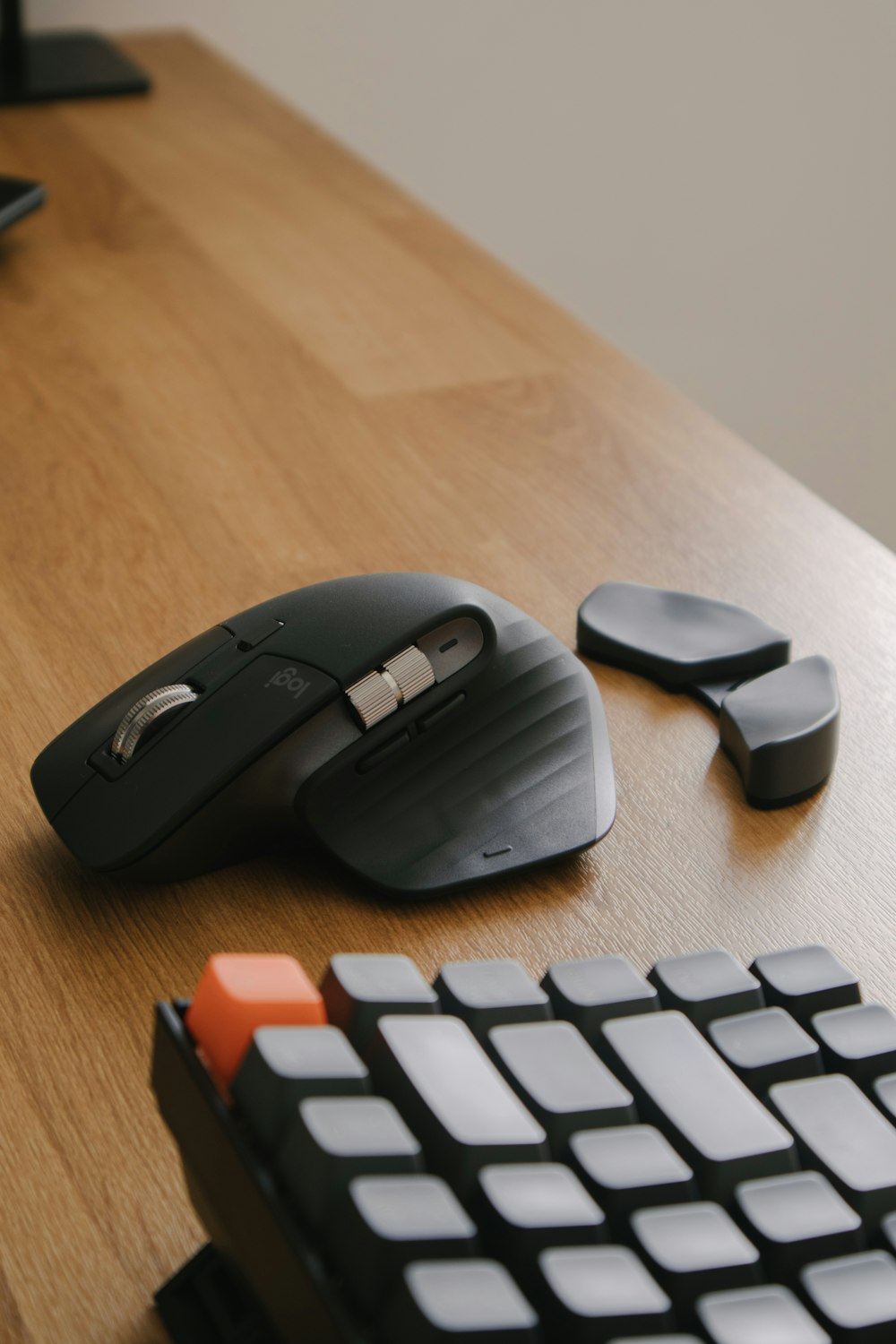 black cordless computer mouse on brown wooden desk