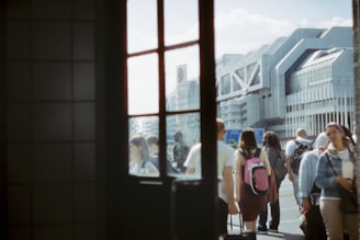 A scenic view of travelers exploring a vibrant city street with luggage.