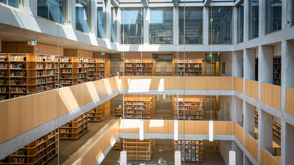 brown wooden book shelves in library