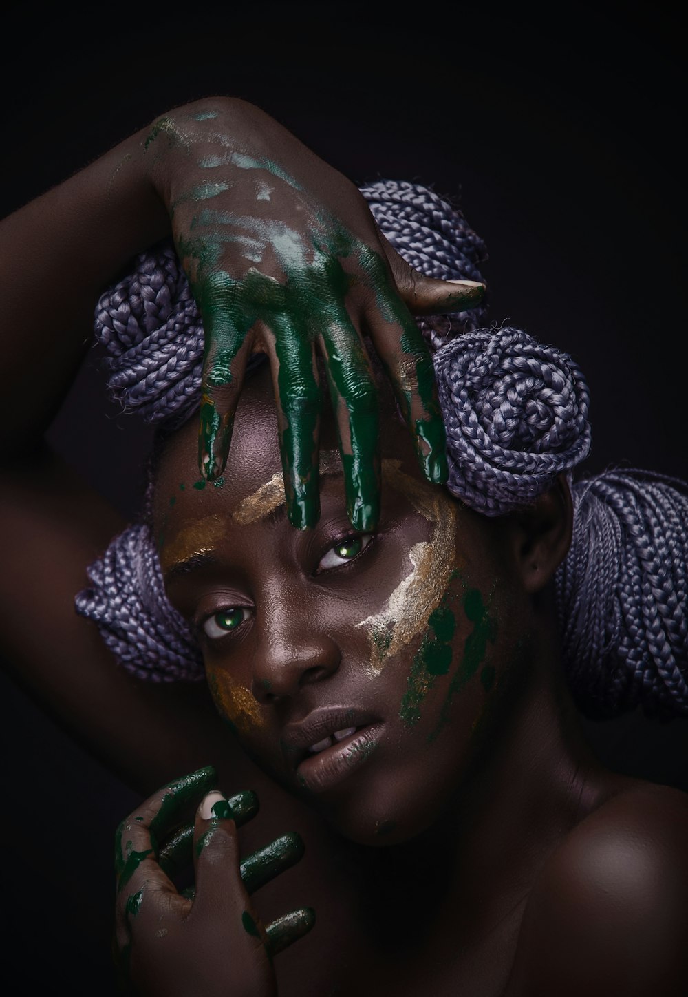woman with green and white paint on face