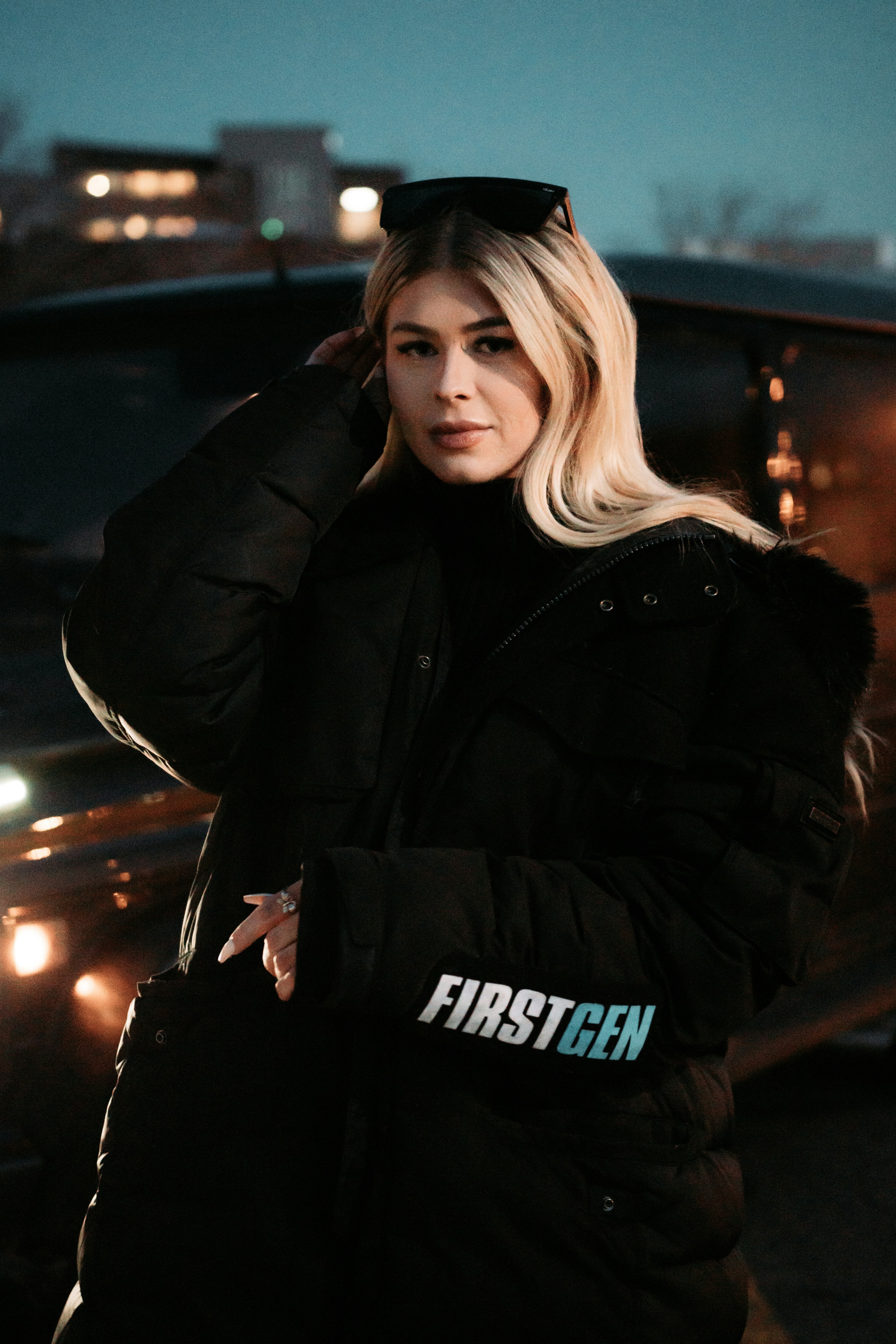 Woman in black leather jacket standing on street during night time ...