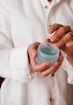 person holding blue plastic container