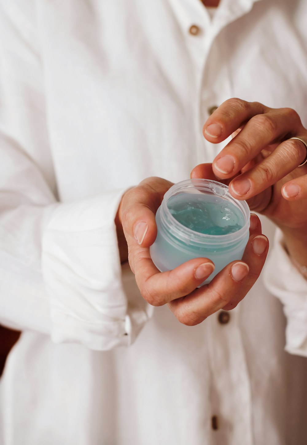 person holding blue plastic container