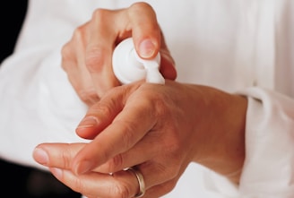 person holding white round ornament