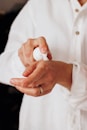 person holding white round ornament
