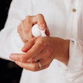 person holding white round ornament