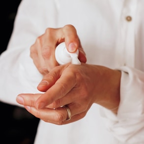 person holding white round ornament