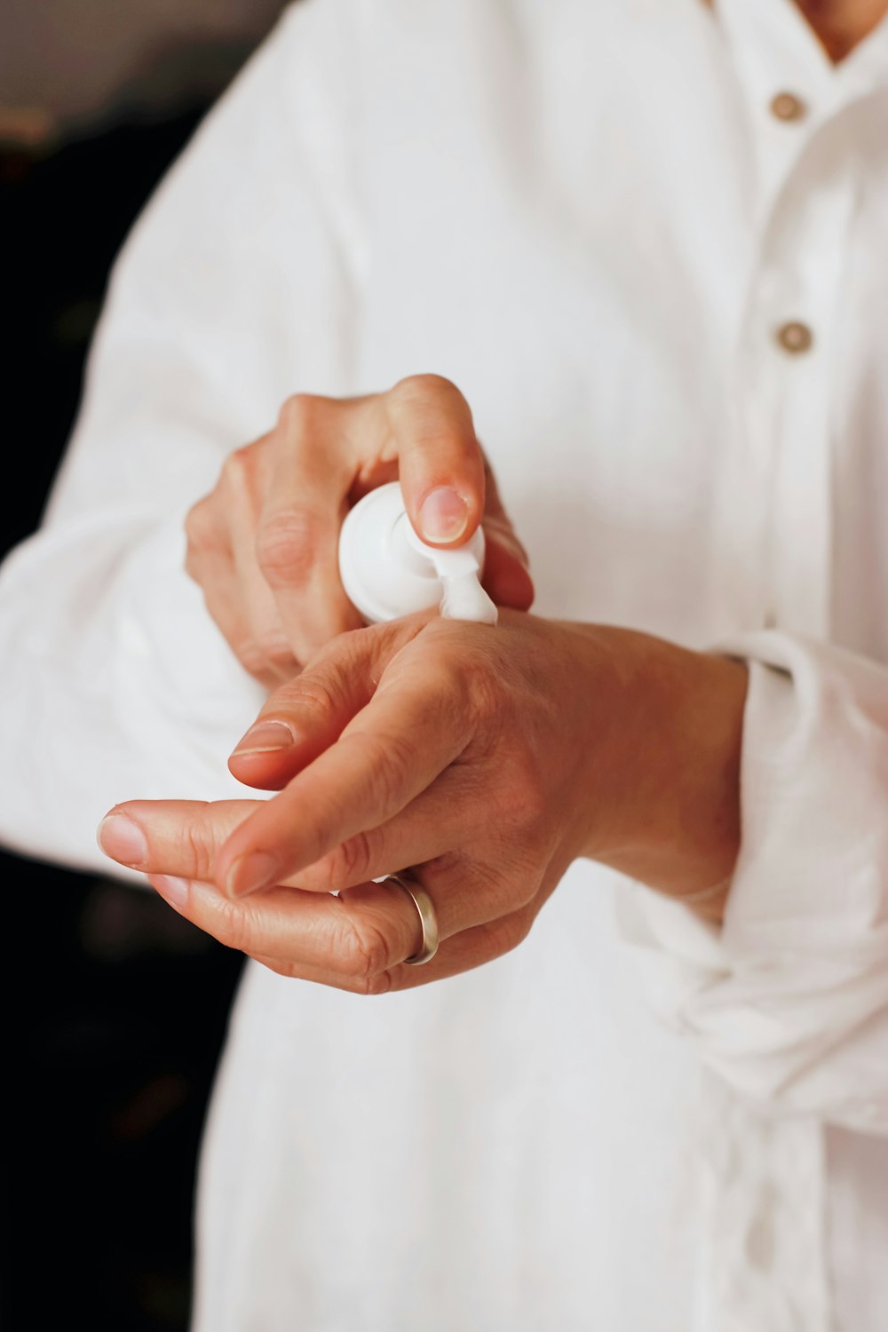 Woman applying lotion on her hand