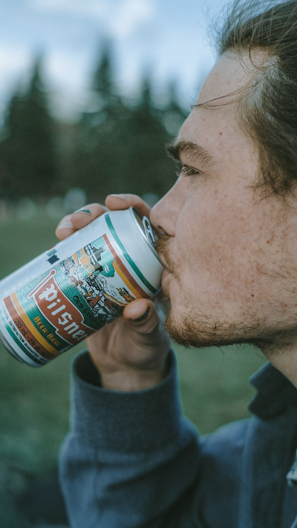 man drinking beer from can