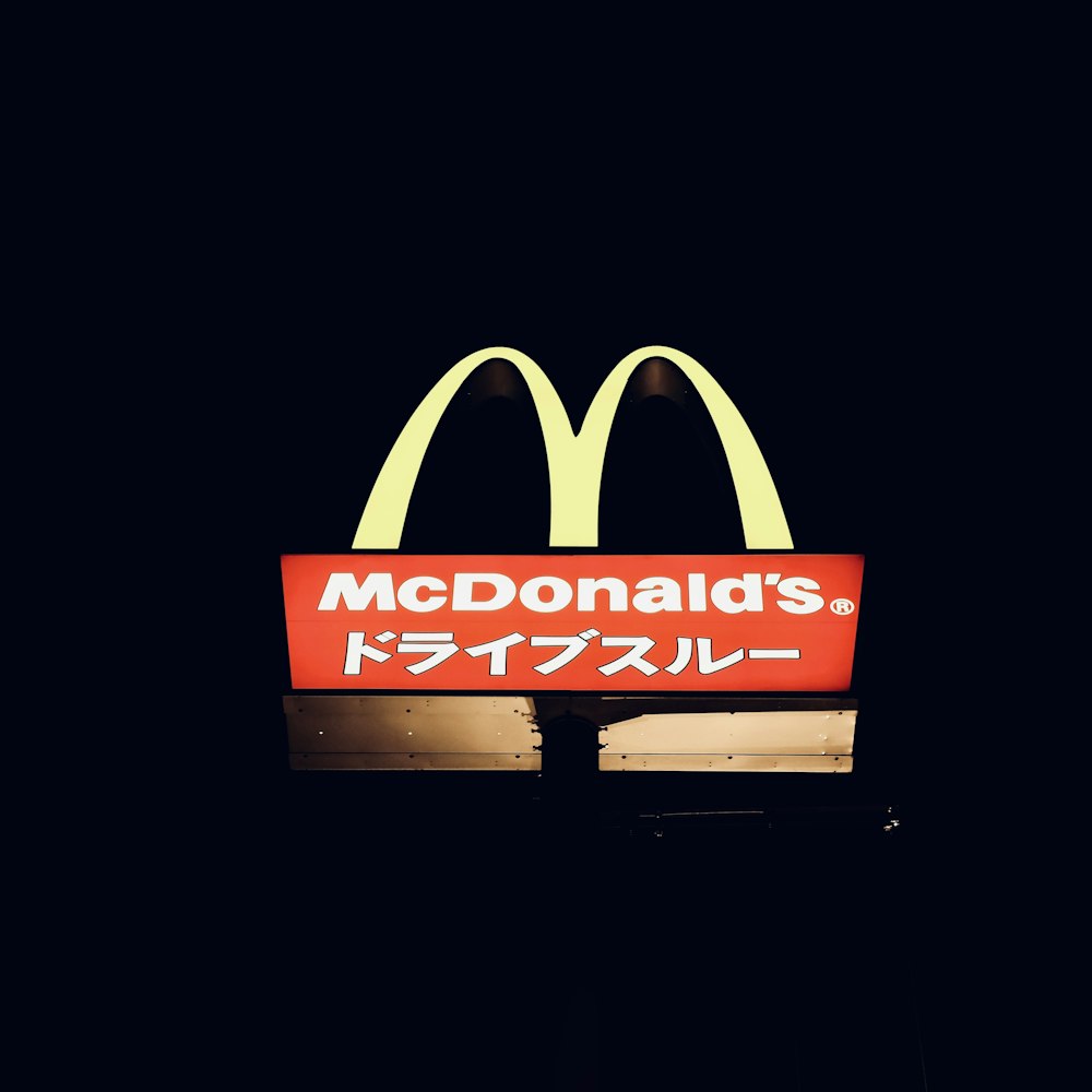 a mcdonald's restaurant sign lit up at night