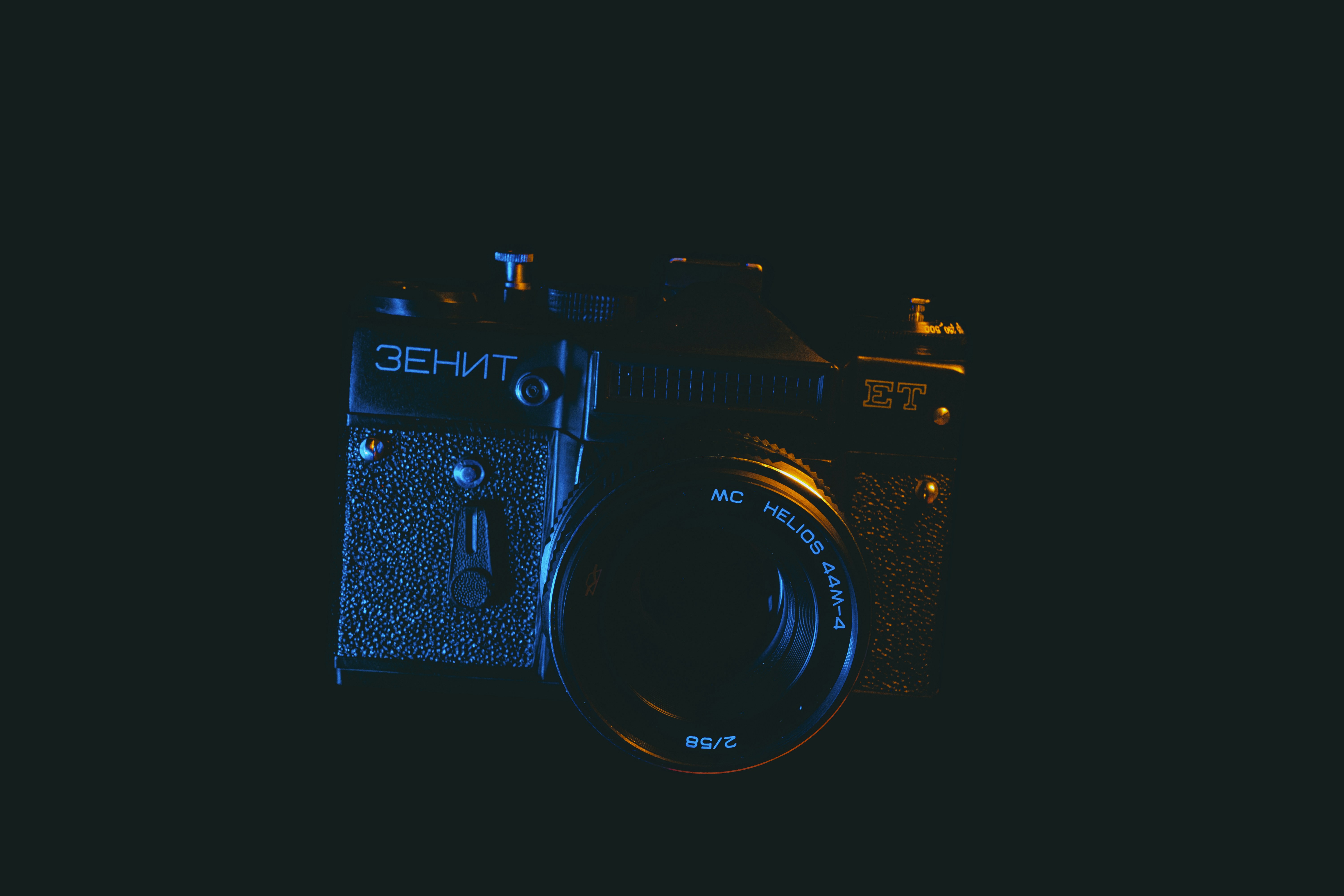black nikon dslr camera on white surface