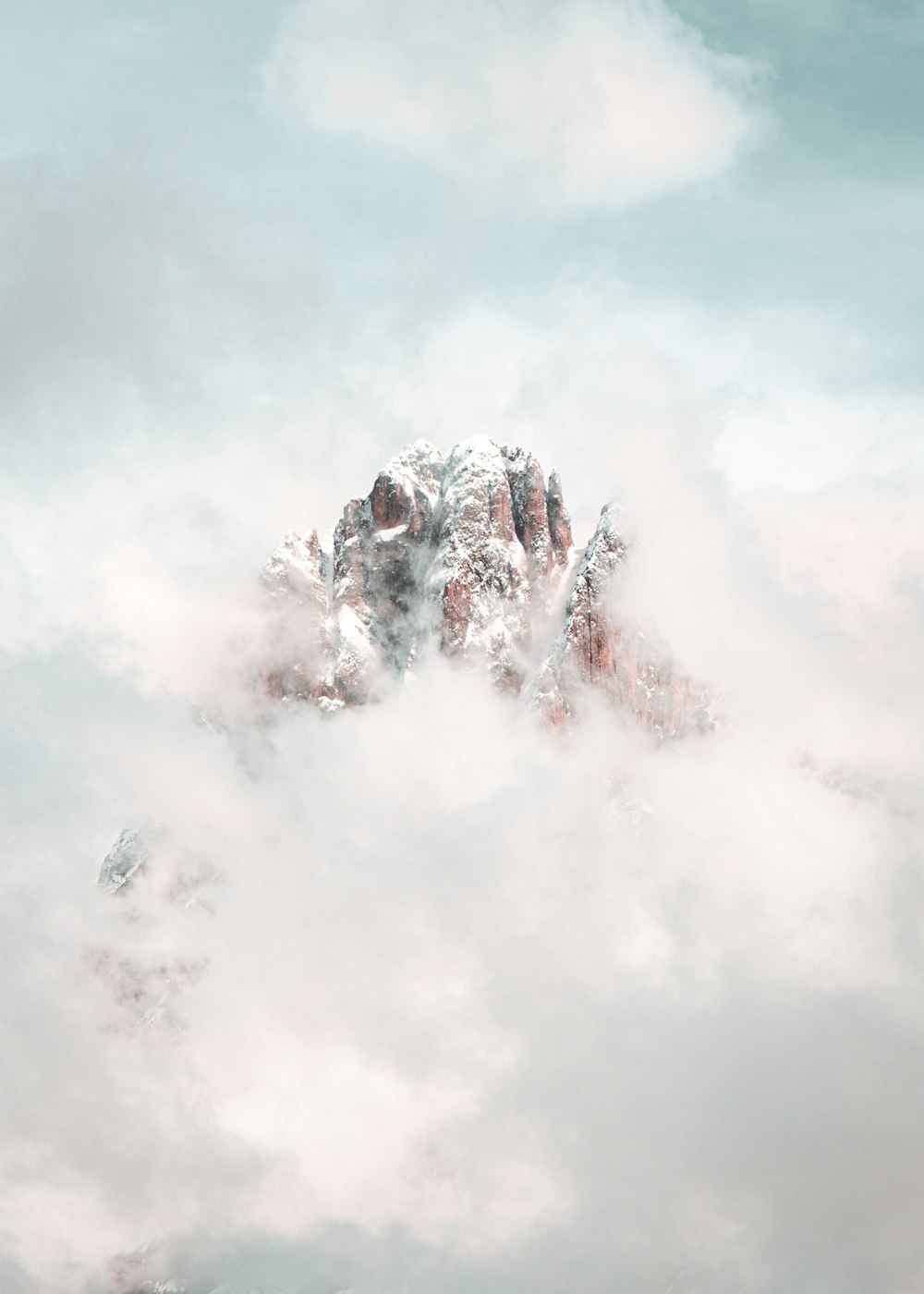 white clouds over snow covered mountain