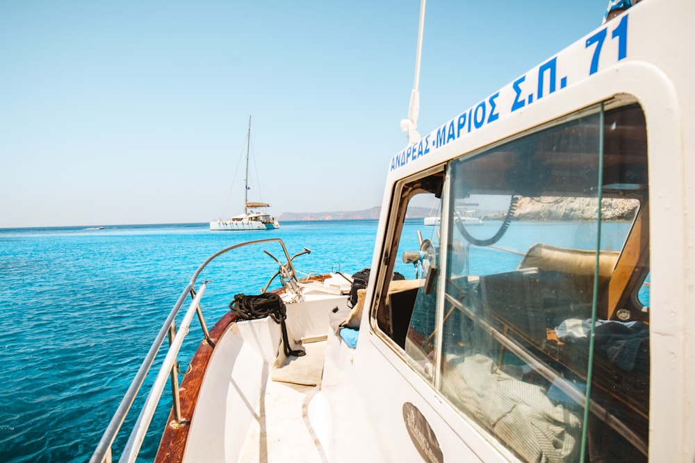 white and blue yacht on sea during daytime