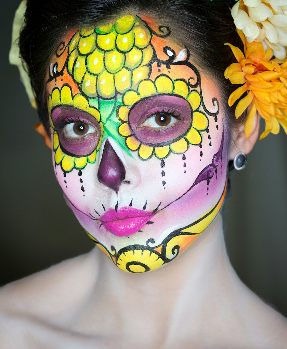 woman with yellow and green floral face paint