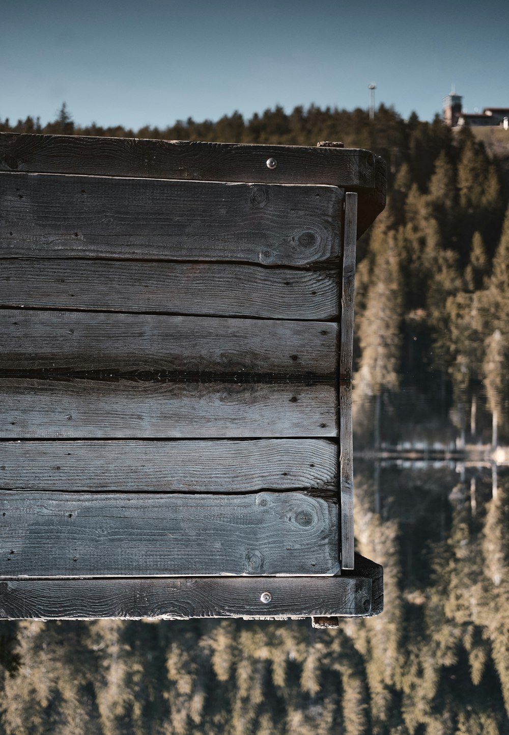 brown wooden plank near body of water