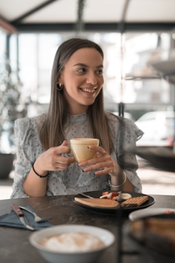 photography poses for dining,how to photograph woman in gray long sleeve shirt holding white ceramic mug