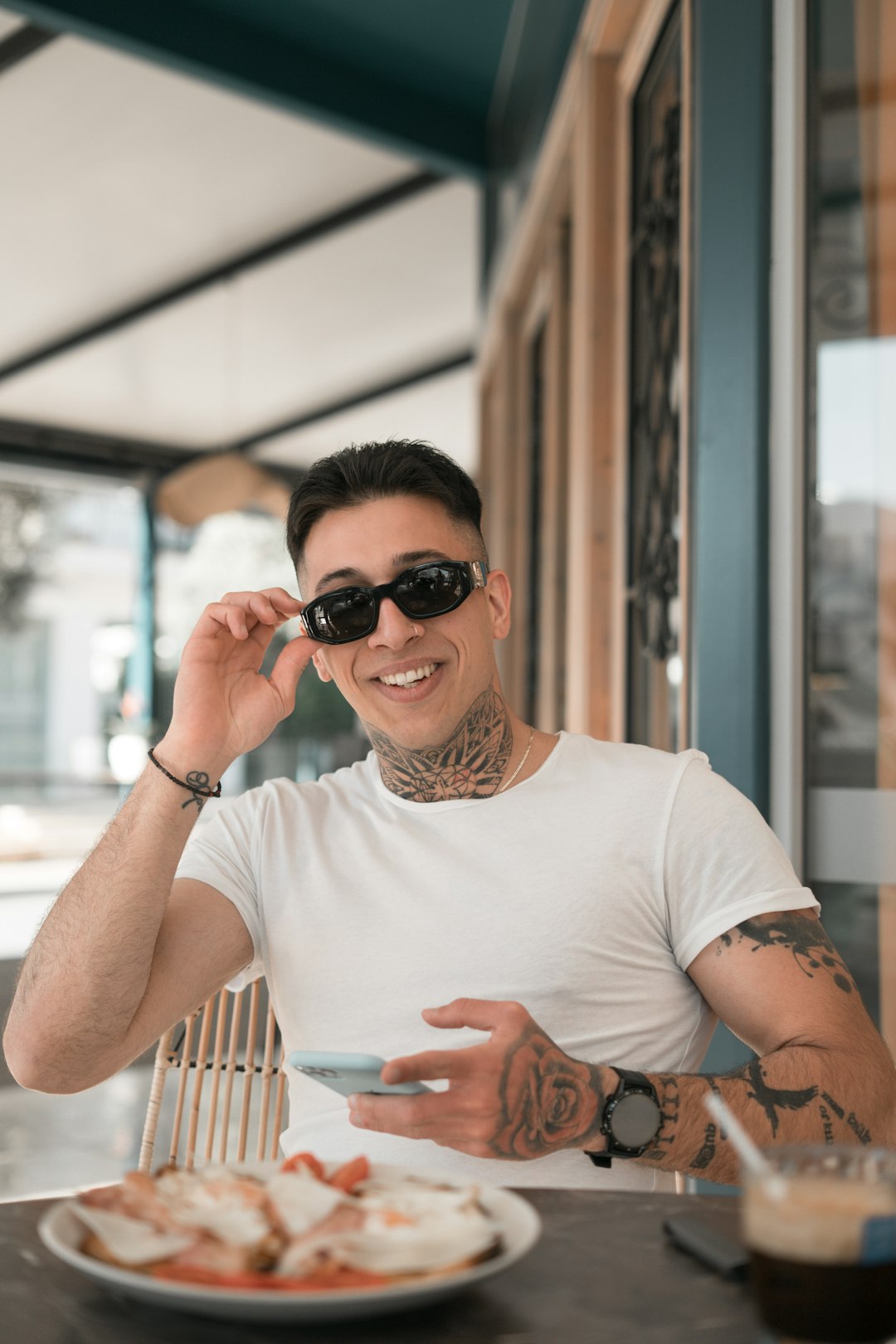 woman in white crew neck t-shirt wearing black sunglasses