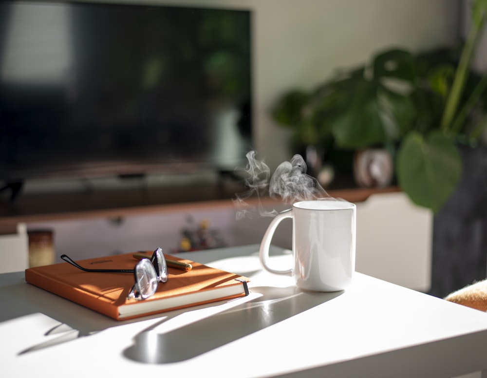 white ceramic mug on white table