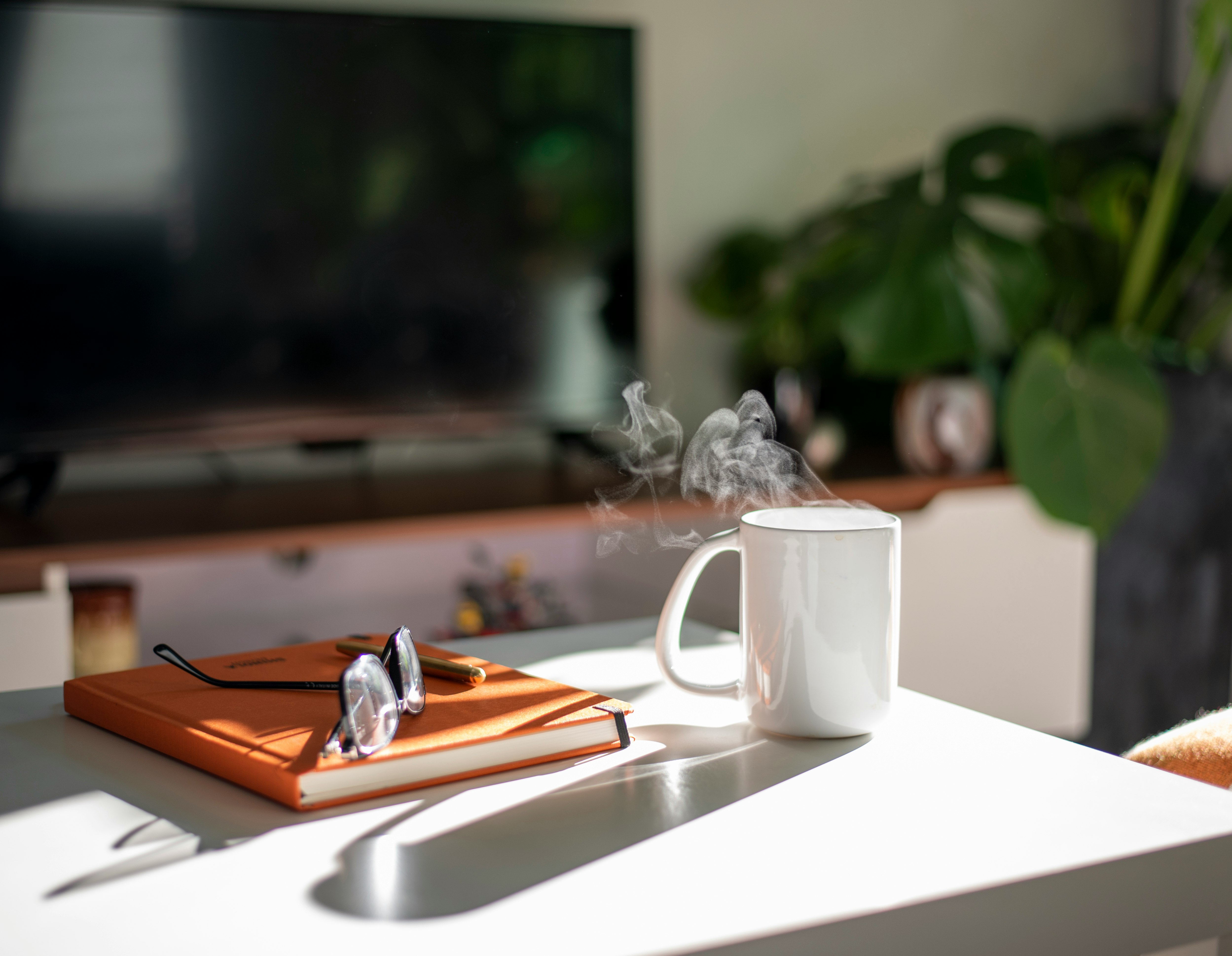 white ceramic mug on white table