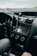 black iphone 4 on car center console