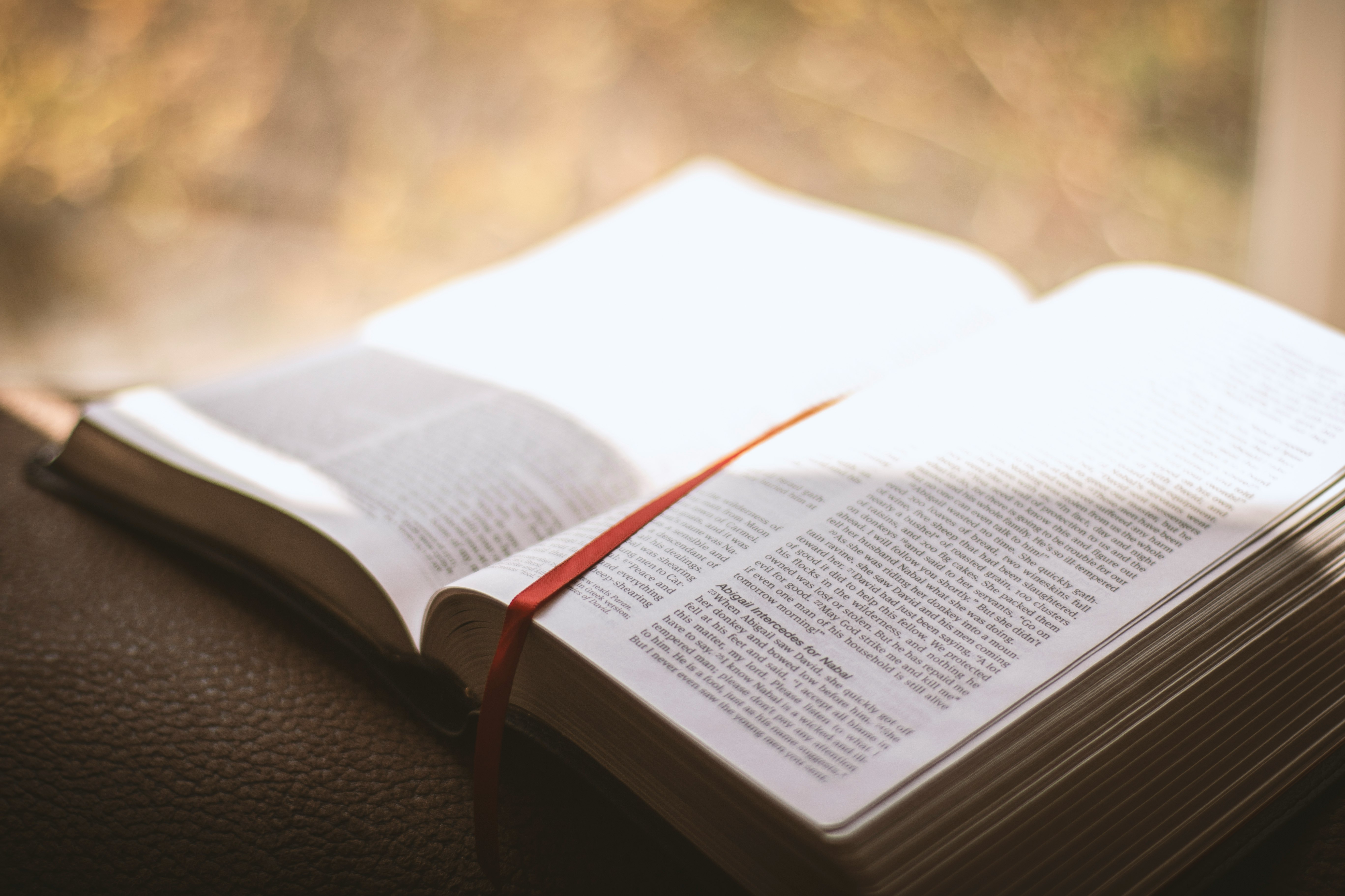 white book page on black leather chair