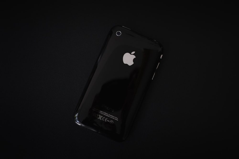 black iphone 4 on white surface